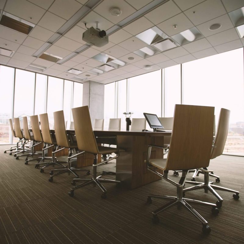 Empty conference room with large windows.