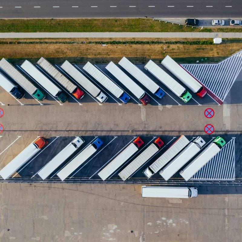 Aerial view of trucks parked in line.