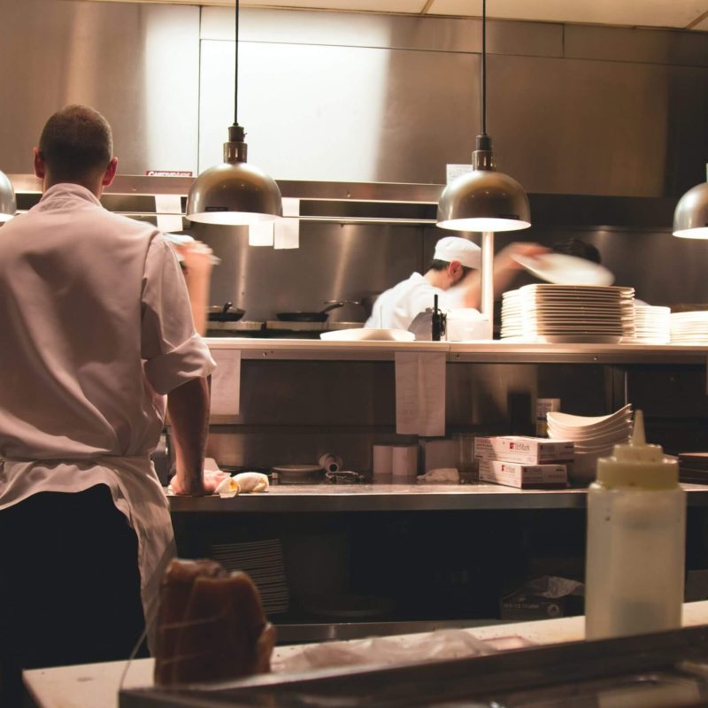 Chefs working in a busy restaurant kitchen.